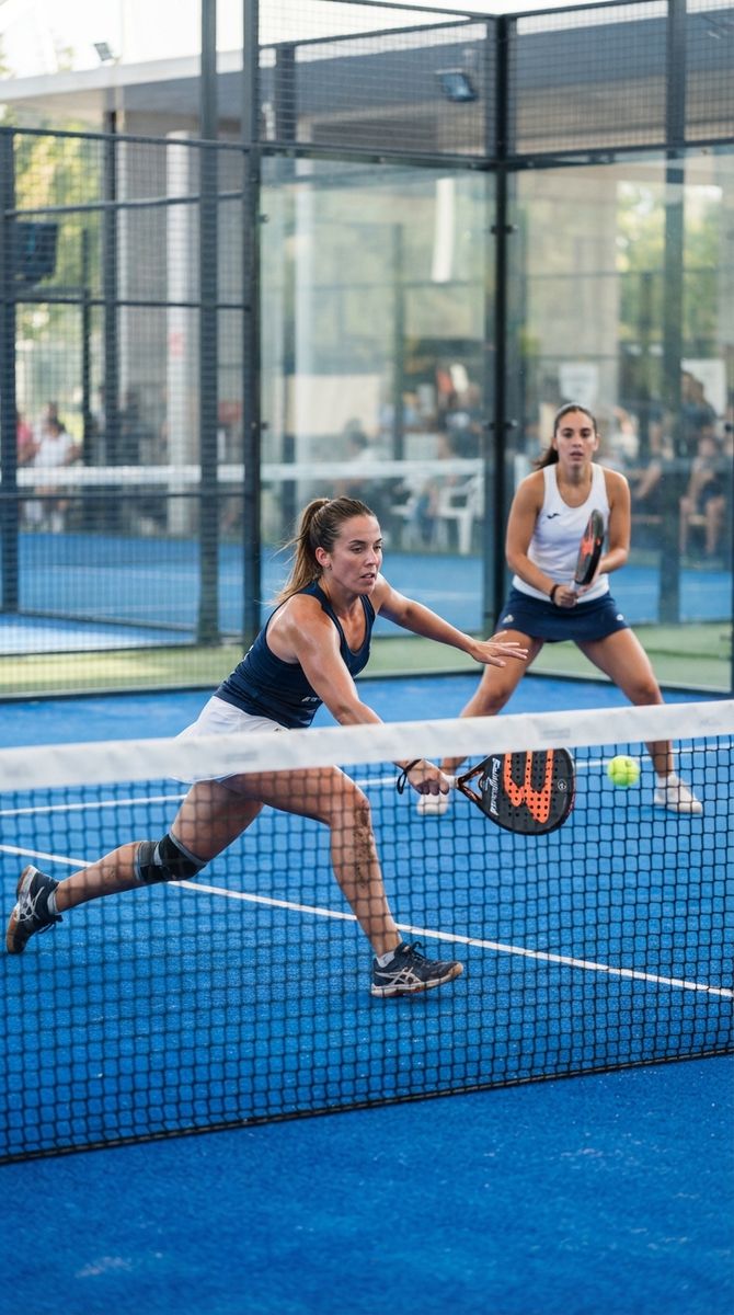 Doubles players at the net on a blue padel court